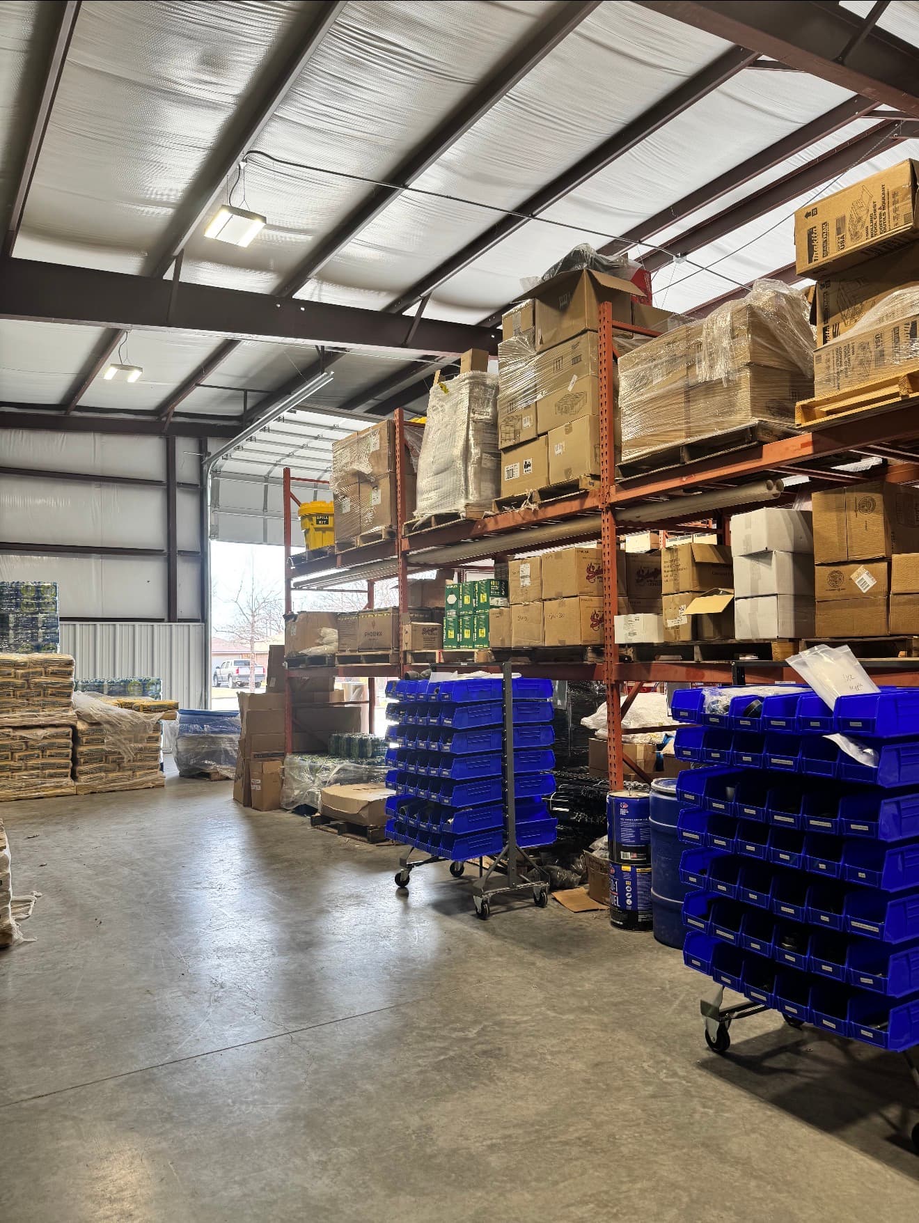 Warehouse racks with supply bins and boxed products